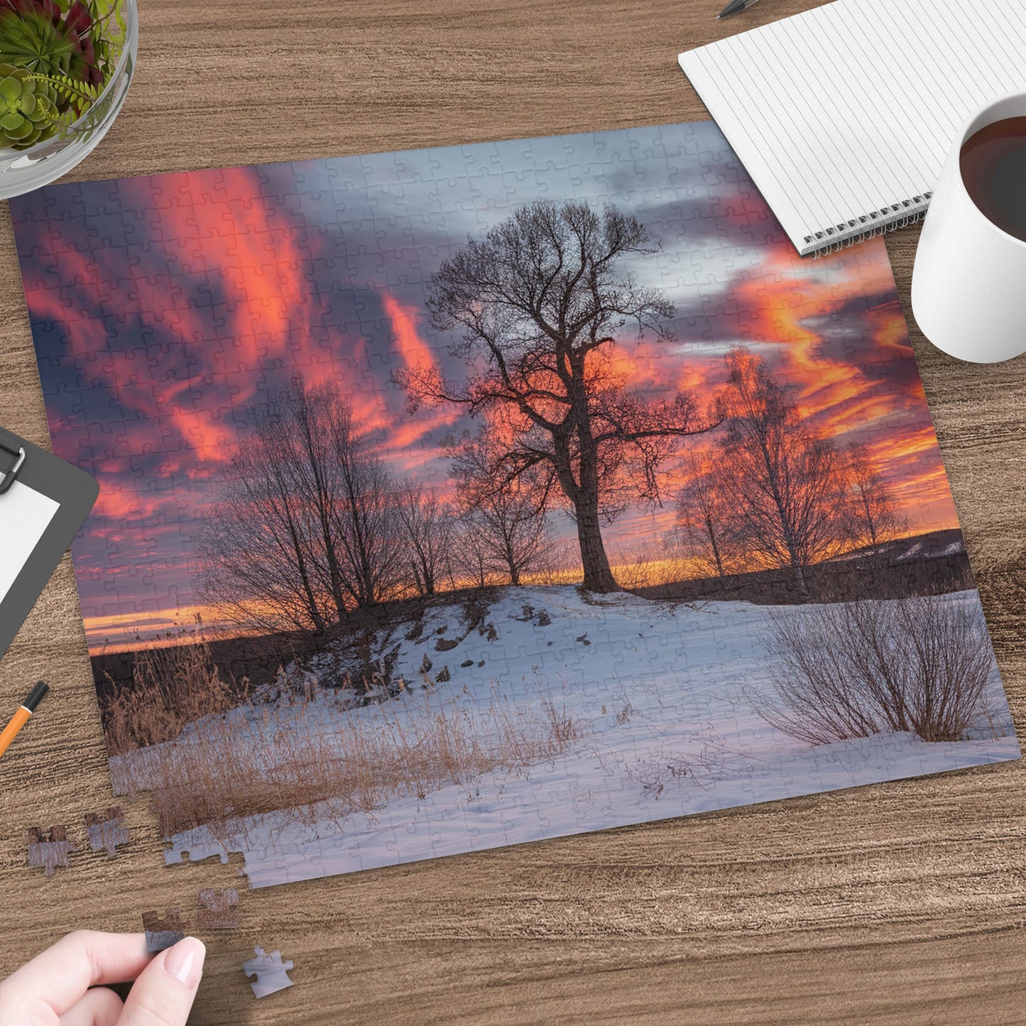 Winter sunset jigsaw puzzle featuring a lone tree on a snowy hill.
