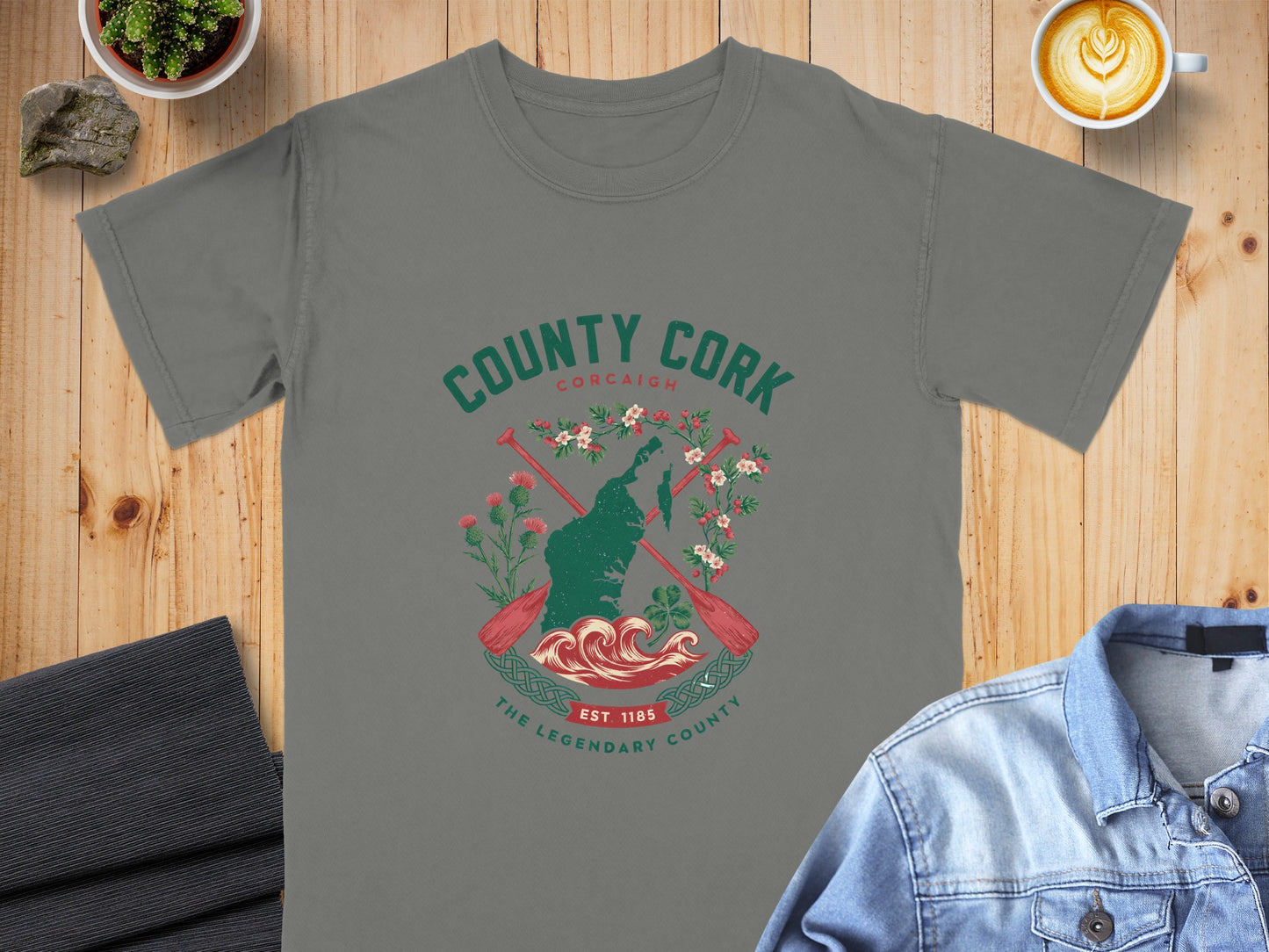 Grey t-shirt featuring "County Cork" design with oars, flowers, and waves.