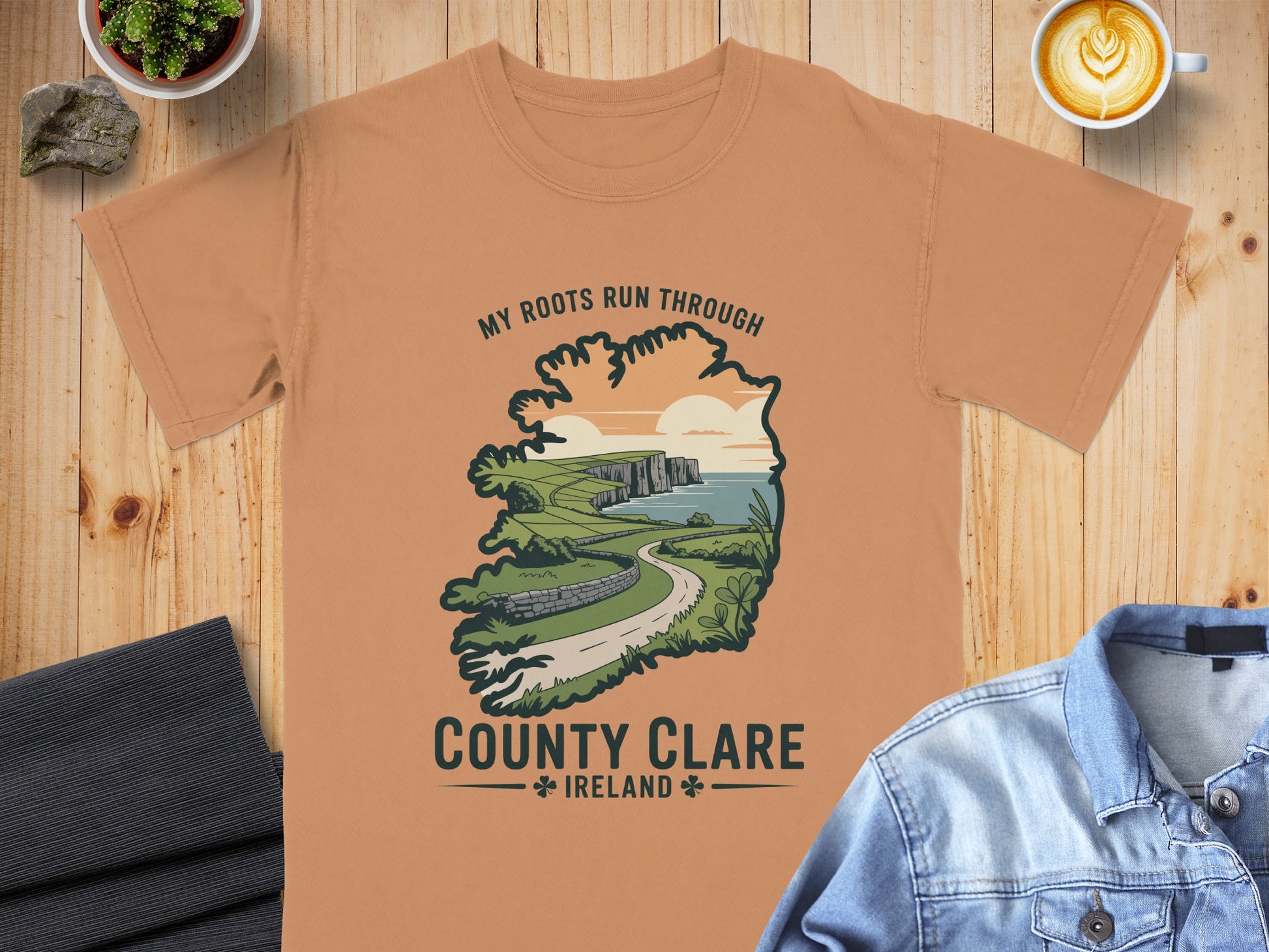 T-shirt with "My Roots Run Through County Clare, Ireland" text and landscape illustration.