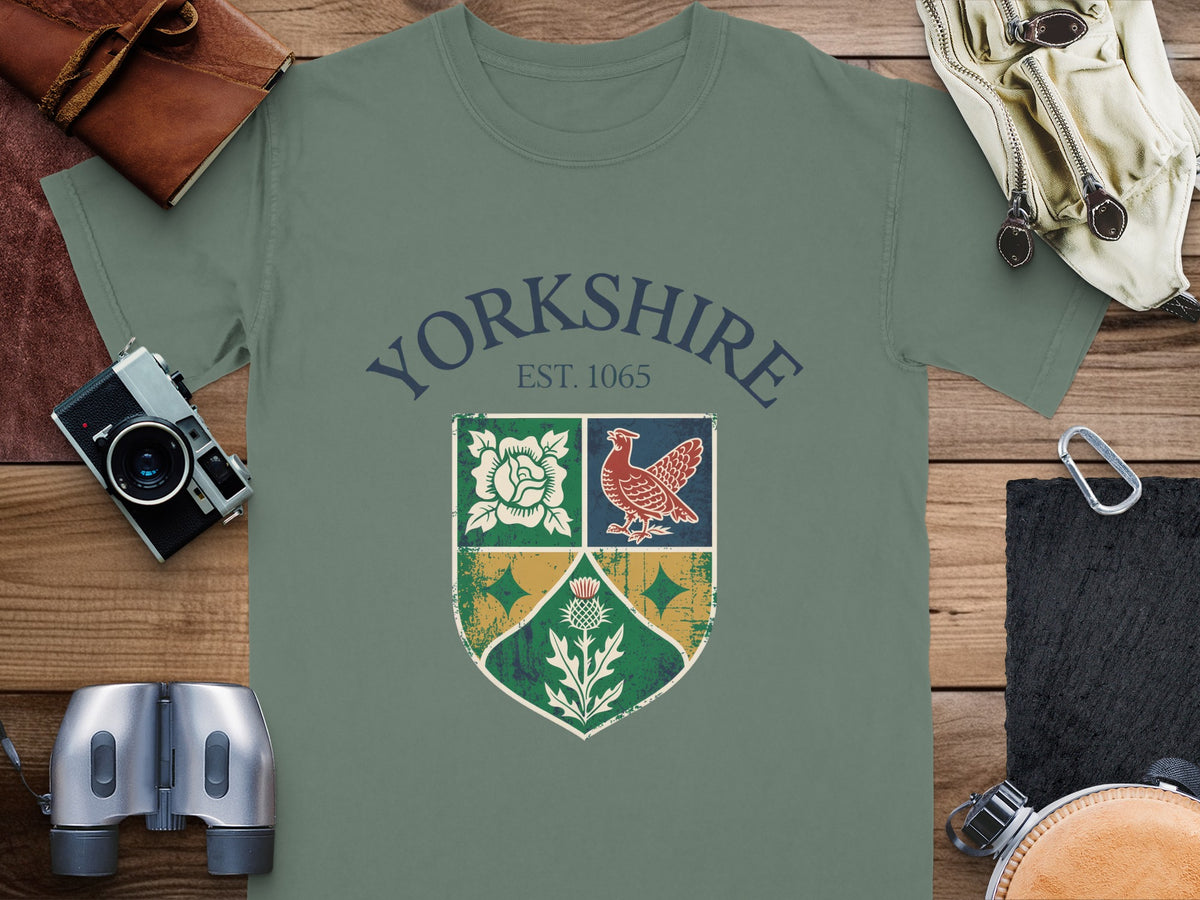 Green t-shirt with Yorkshire crest featuring rose, bird, and thistle, Est. 1065.