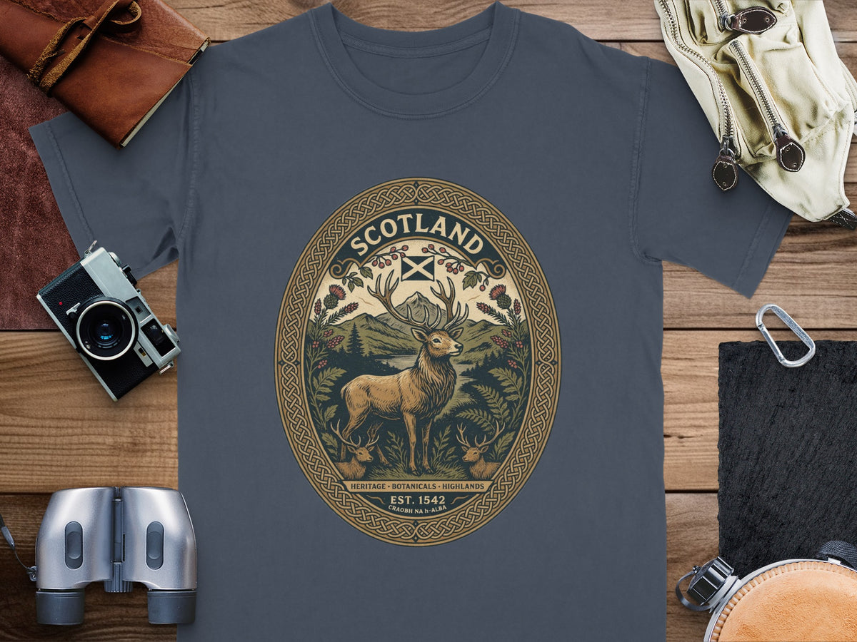 T-shirt with oval Scottish deer graphic, highland scenery, and text.