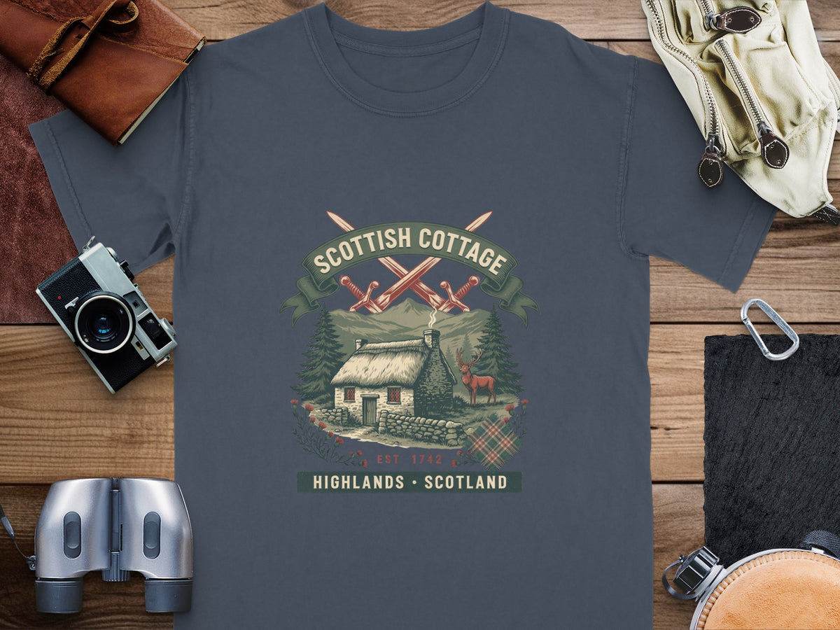 Scottish Cottage graphic with crossed swords, stone cottage, deer, and tartan.