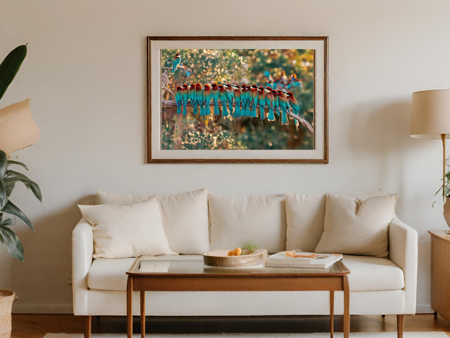 Framed artwork of beeeaters perched on a branch, displayed above a sofa.