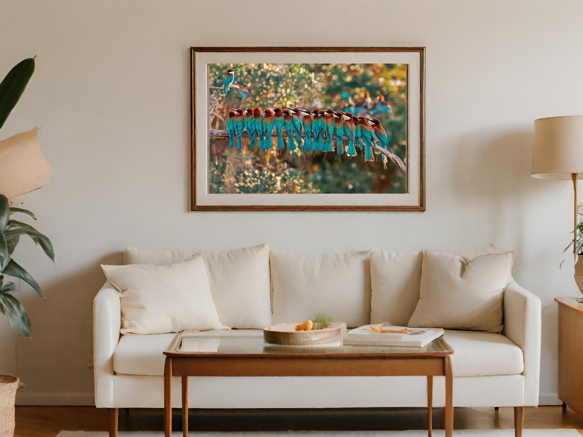 Framed artwork of beeeaters perched on a branch, displayed above a sofa.