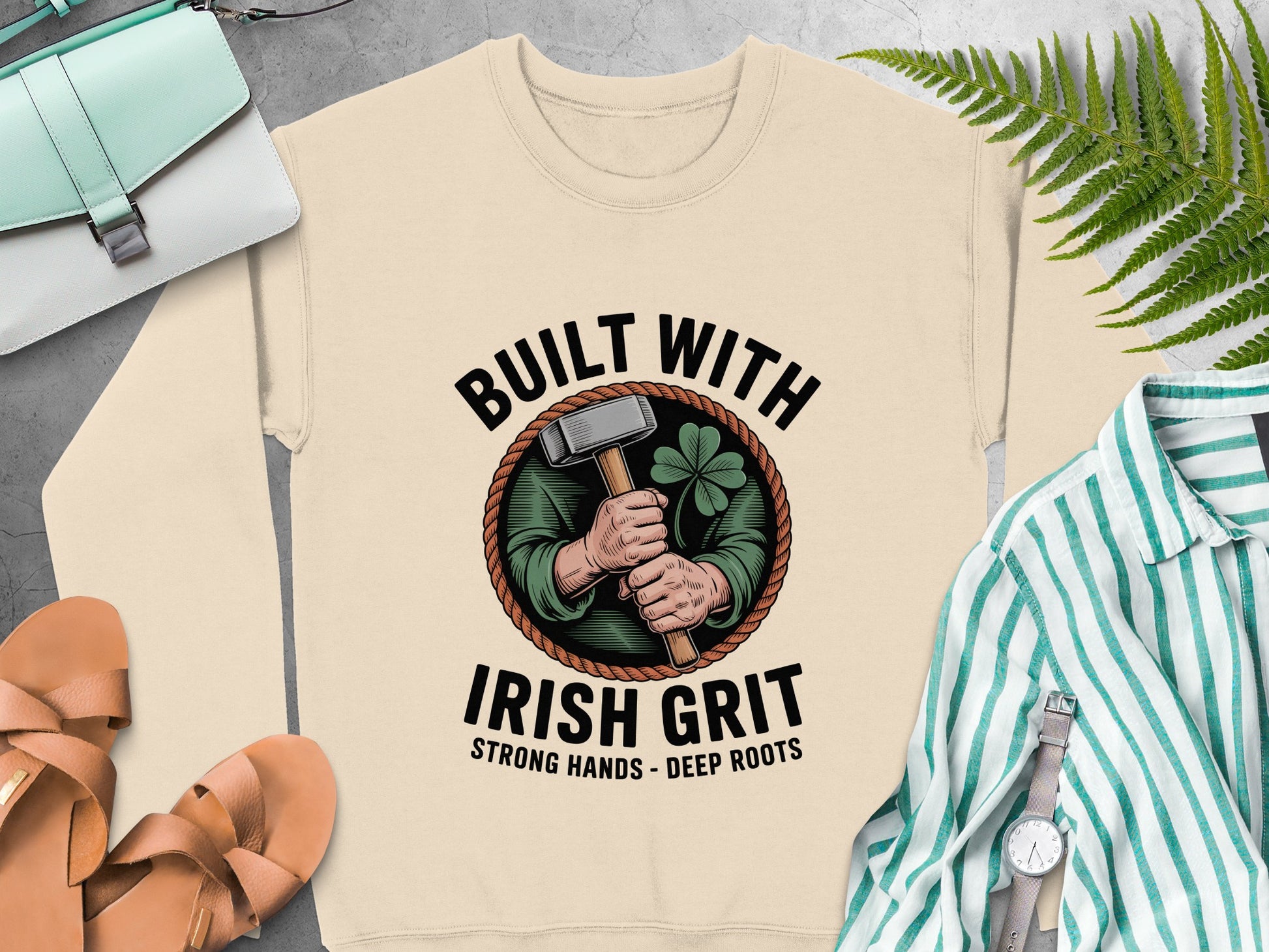 "Built with Irish Grit" graphic featuring a hammer and shamrock on Sand sweatshirt