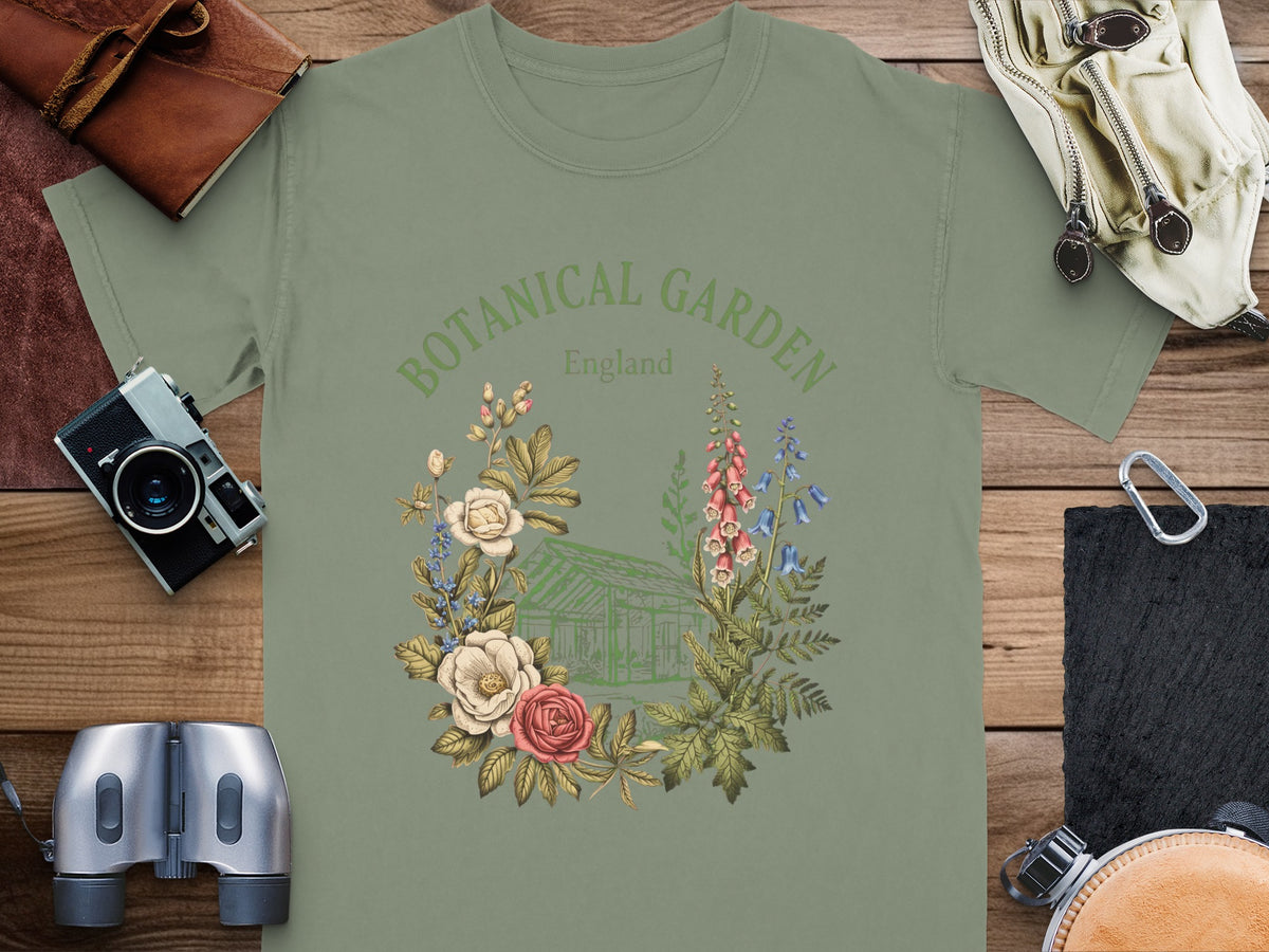 Green t-shirt with botanical illustration of greenhouse, flowers, and text "BOTANICAL GARDEN England".