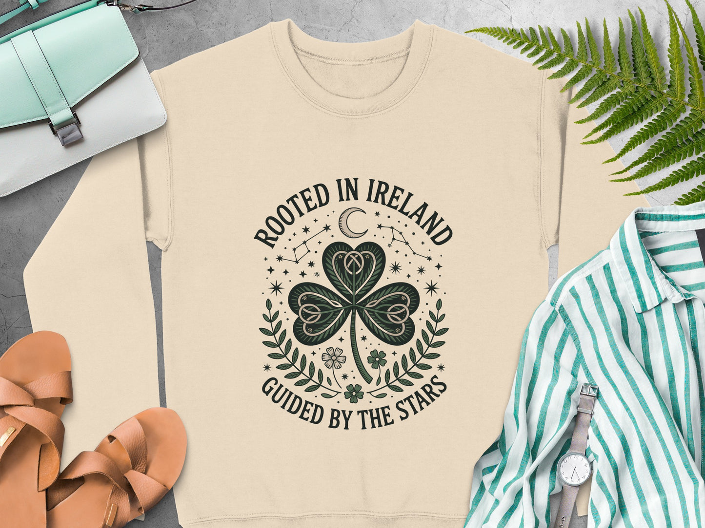"Rooted in Ireland, Guided by the Stars" text and shamrock graphic on Sand sweatshirt