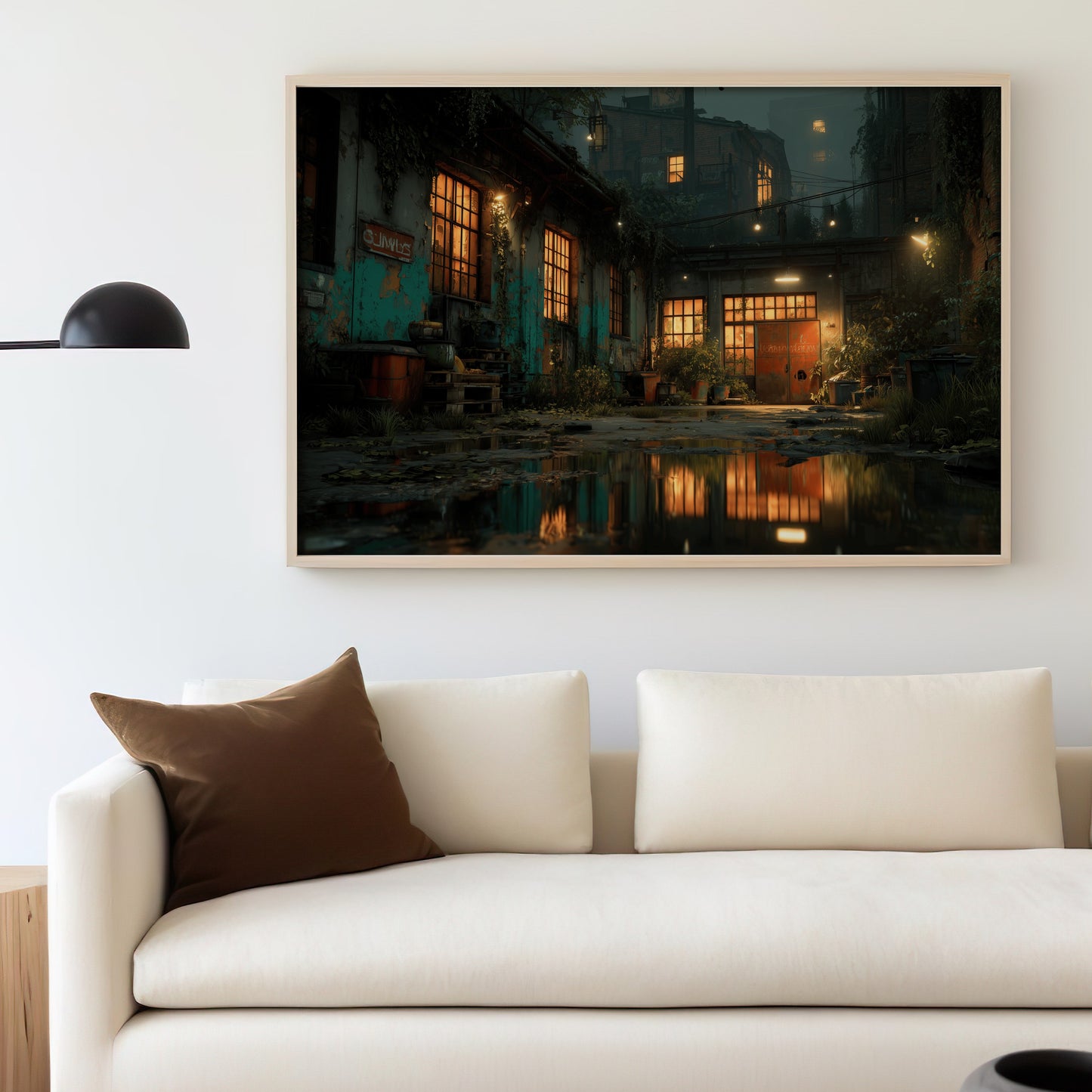 Glow of building windows reflecting on wet ground, framed artwork above a sofa.