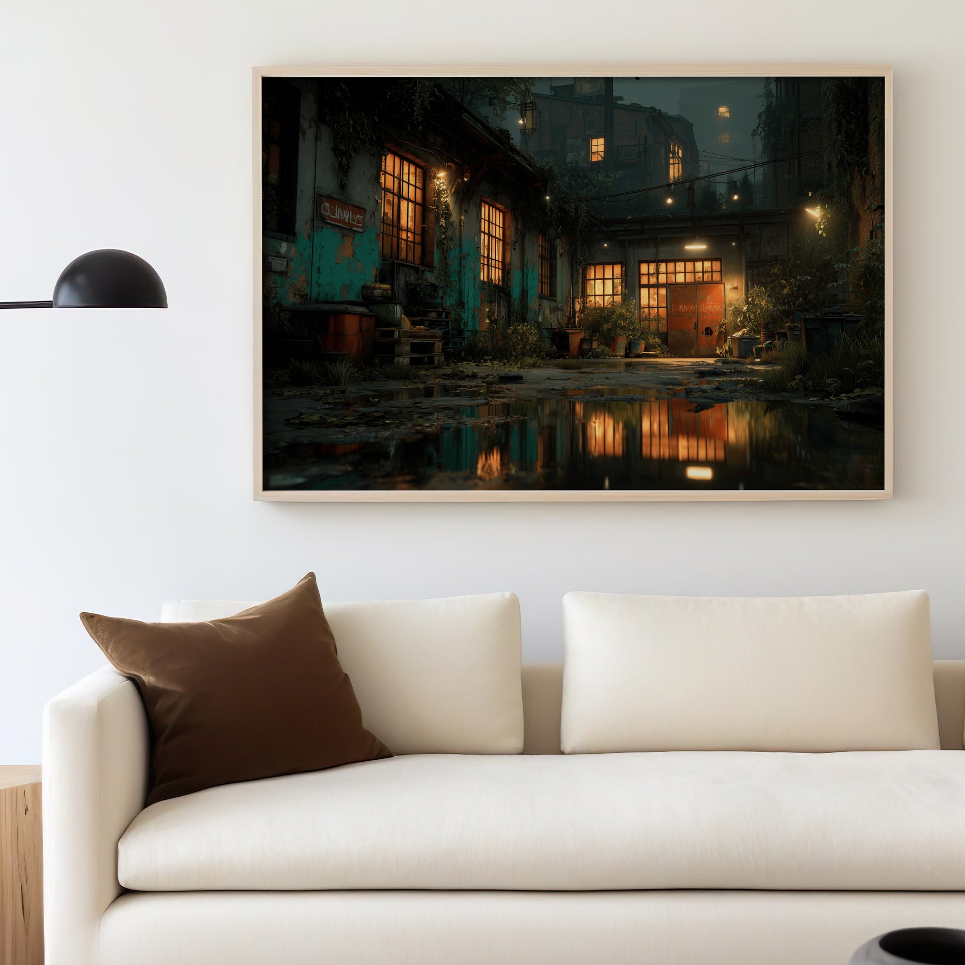 Glow of building windows reflecting on wet ground, framed artwork above a sofa.