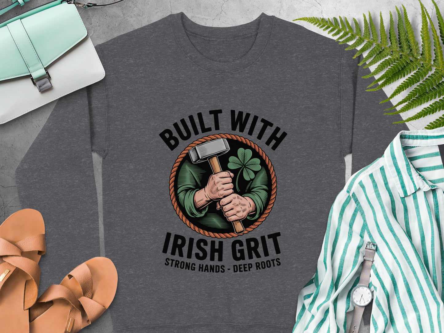 "Built with Irish Grit" and a hammer, shamrock graphic on Dark Heather sweatshirt