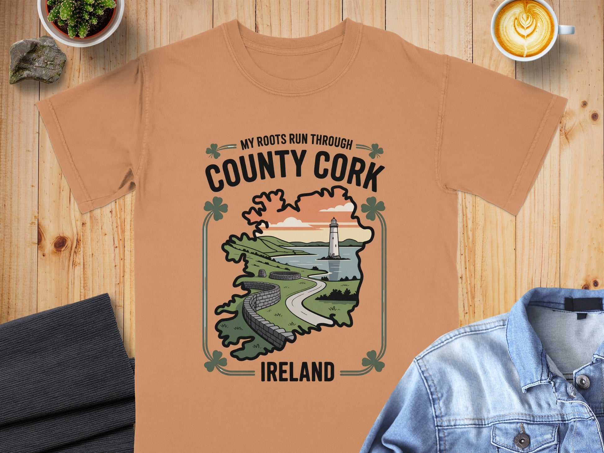 Peach t-shirt with "My Roots Run Through County Cork Ireland" graphic featuring lighthouse and map.