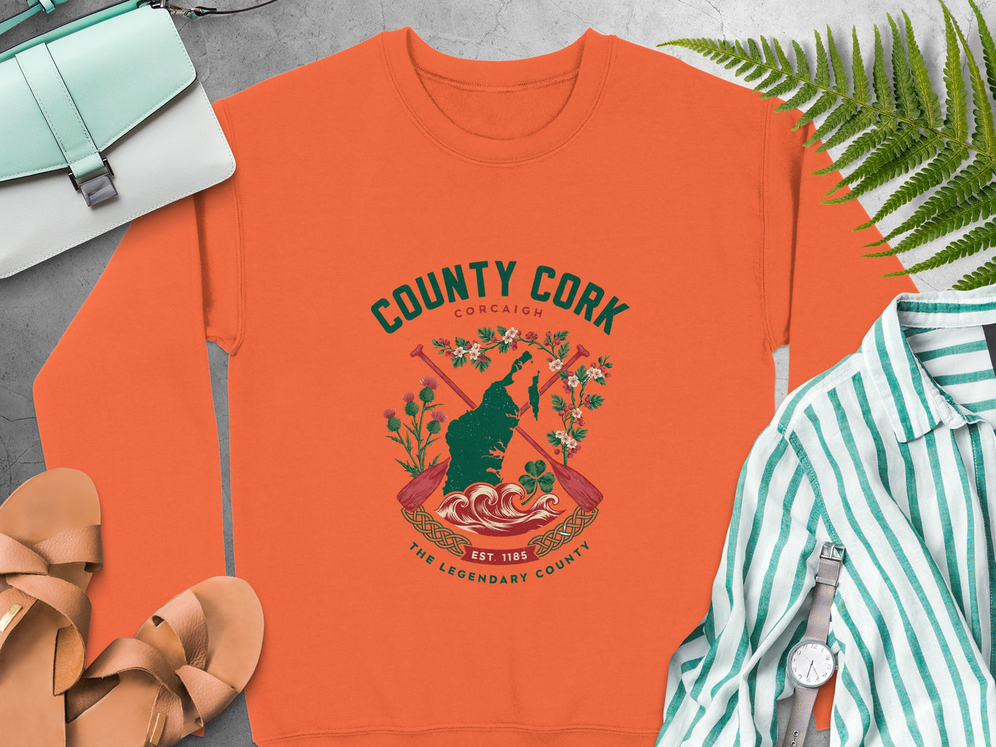 Orange sweatshirt with a County Cork graphic featuring a map, oars, and shamrock.