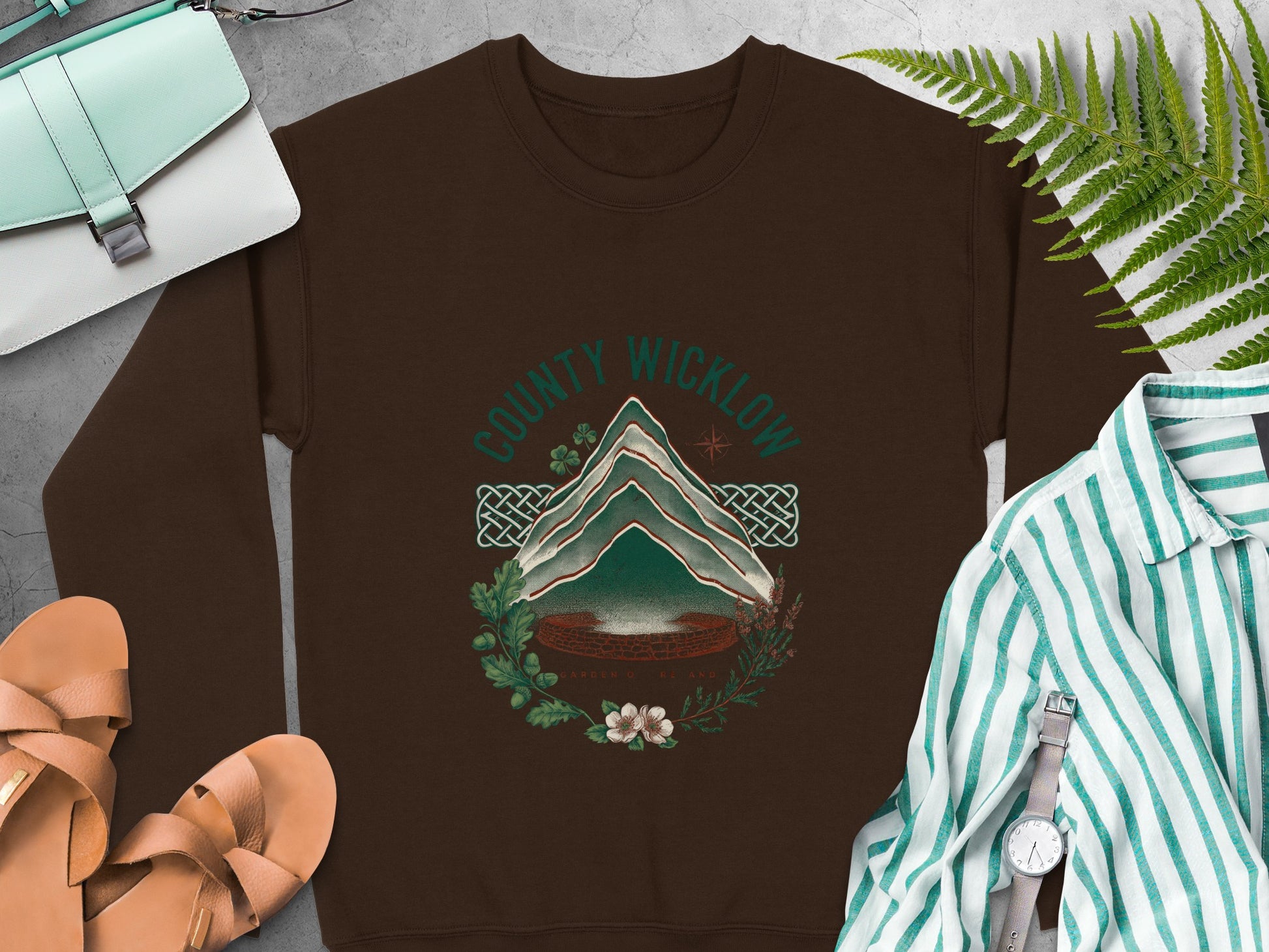 Brown sweatshirt with "County Wicklow Garden of Ireland" circular graphic and mountains.