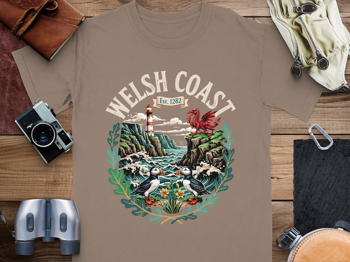 T-shirt graphic with Welsh Coast, lighthouse, dragon, puffins, and daffodils.