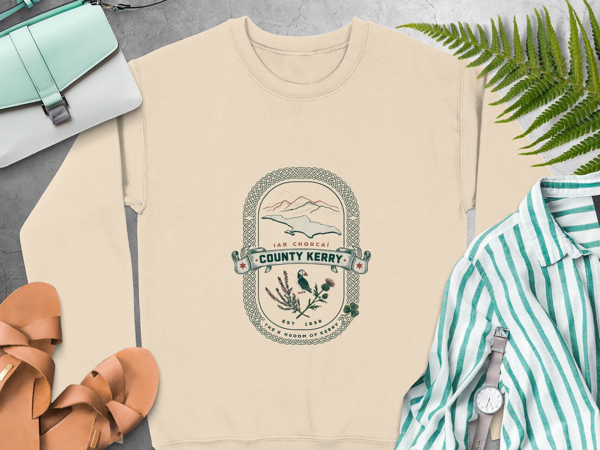 Cream sweatshirt with County Kerry graphic and surrounding accessories.