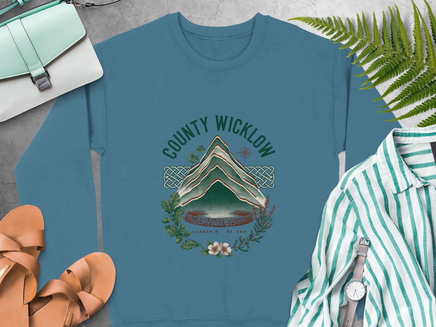 Teal sweatshirt with "County Wicklow Garden of Ireland" circular graphic of mountains and flora.