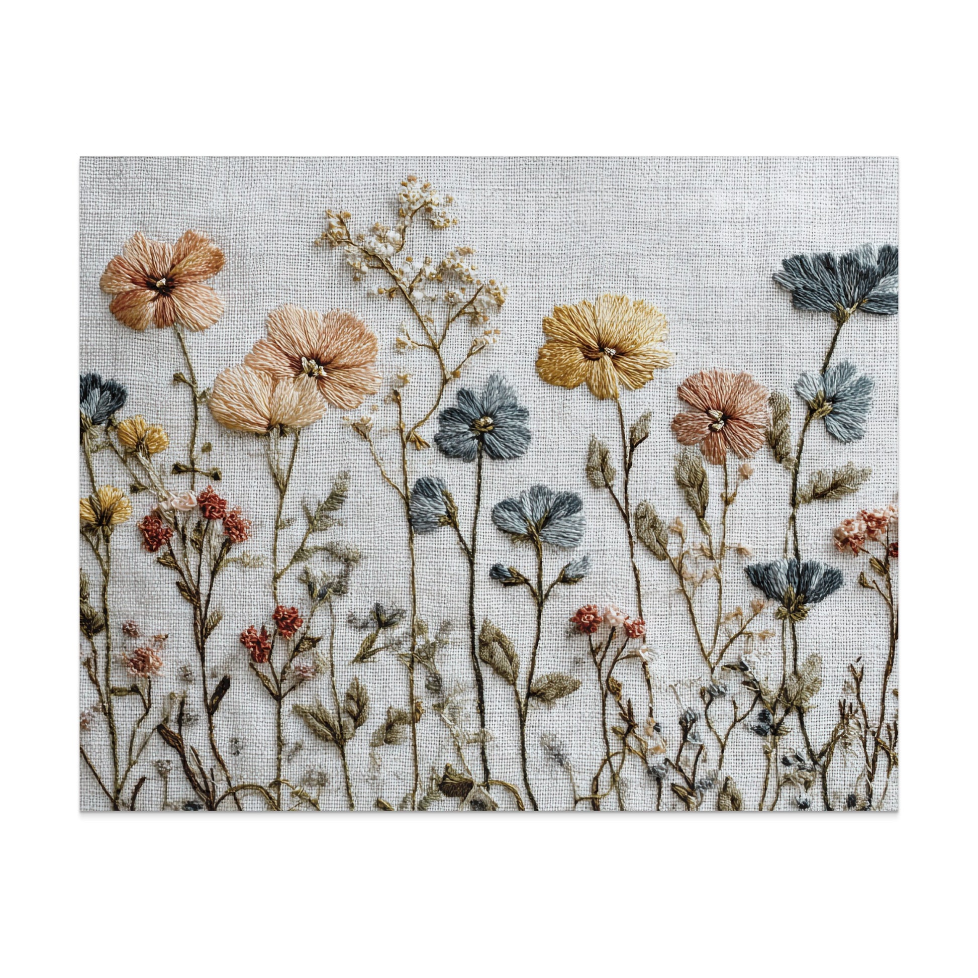 Embroidered wildflowers in muted peach, blue, and yellow on a white linen background.