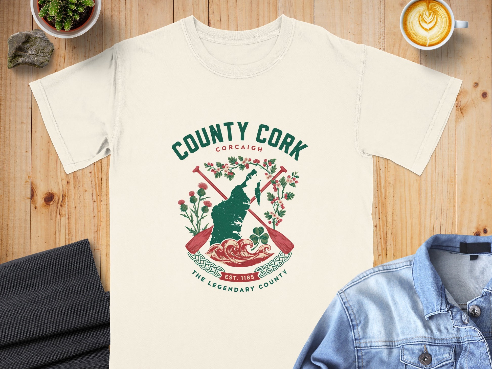 County Cork graphic on a cream t-shirt with paddles and flora.