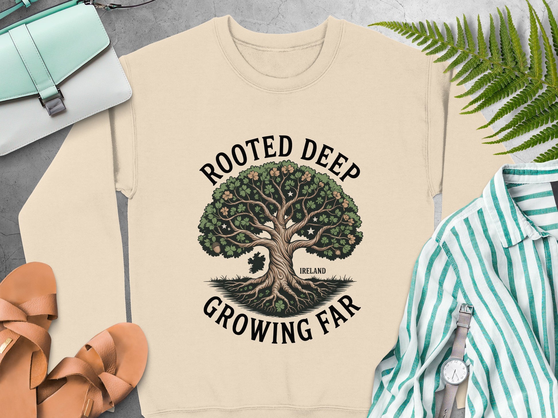 "Rooted Deep, Growing Far" tree graphic and "Ireland" text on Sand sweatshirt