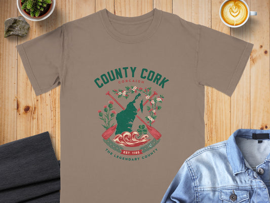 County Cork graphic on a taupe t-shirt with waves, paddles, and clover.
