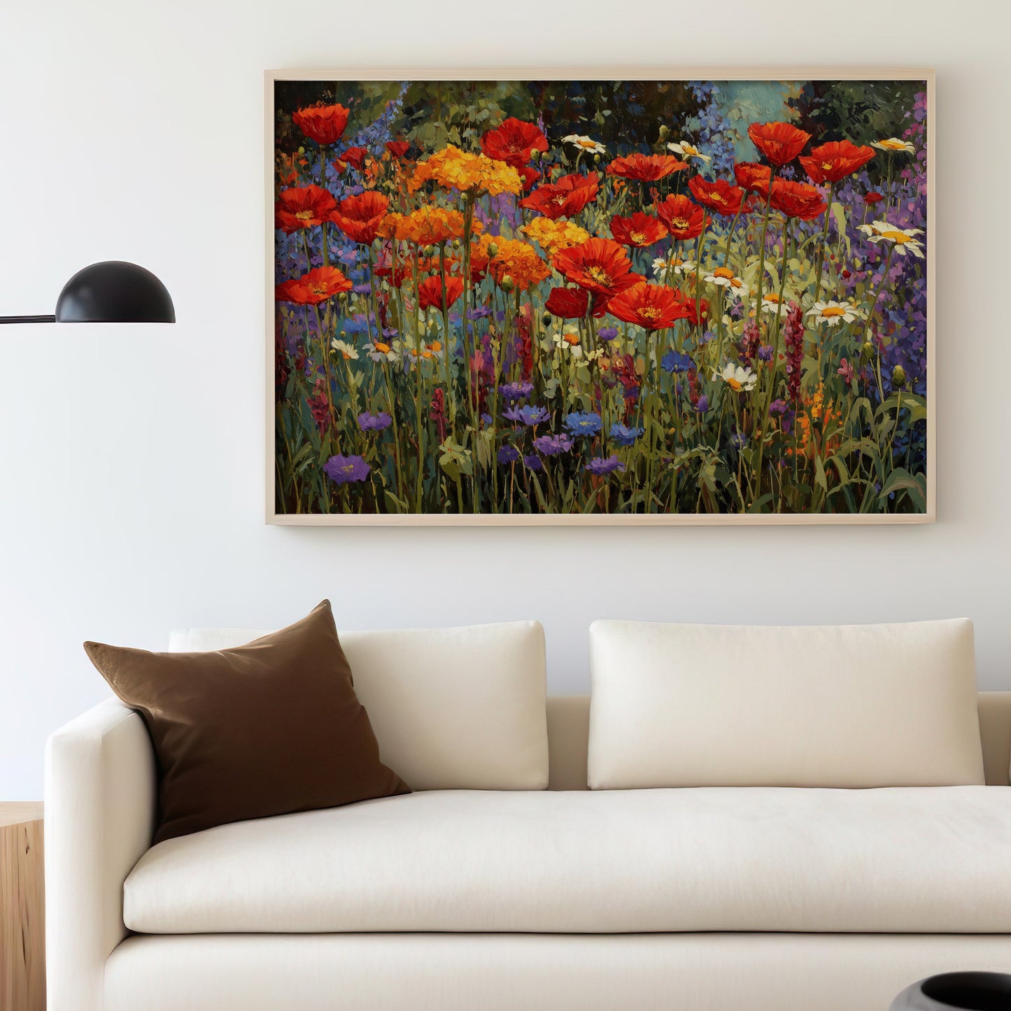 Floral artwork of red, orange, and purple wildflowers above a cream sofa.