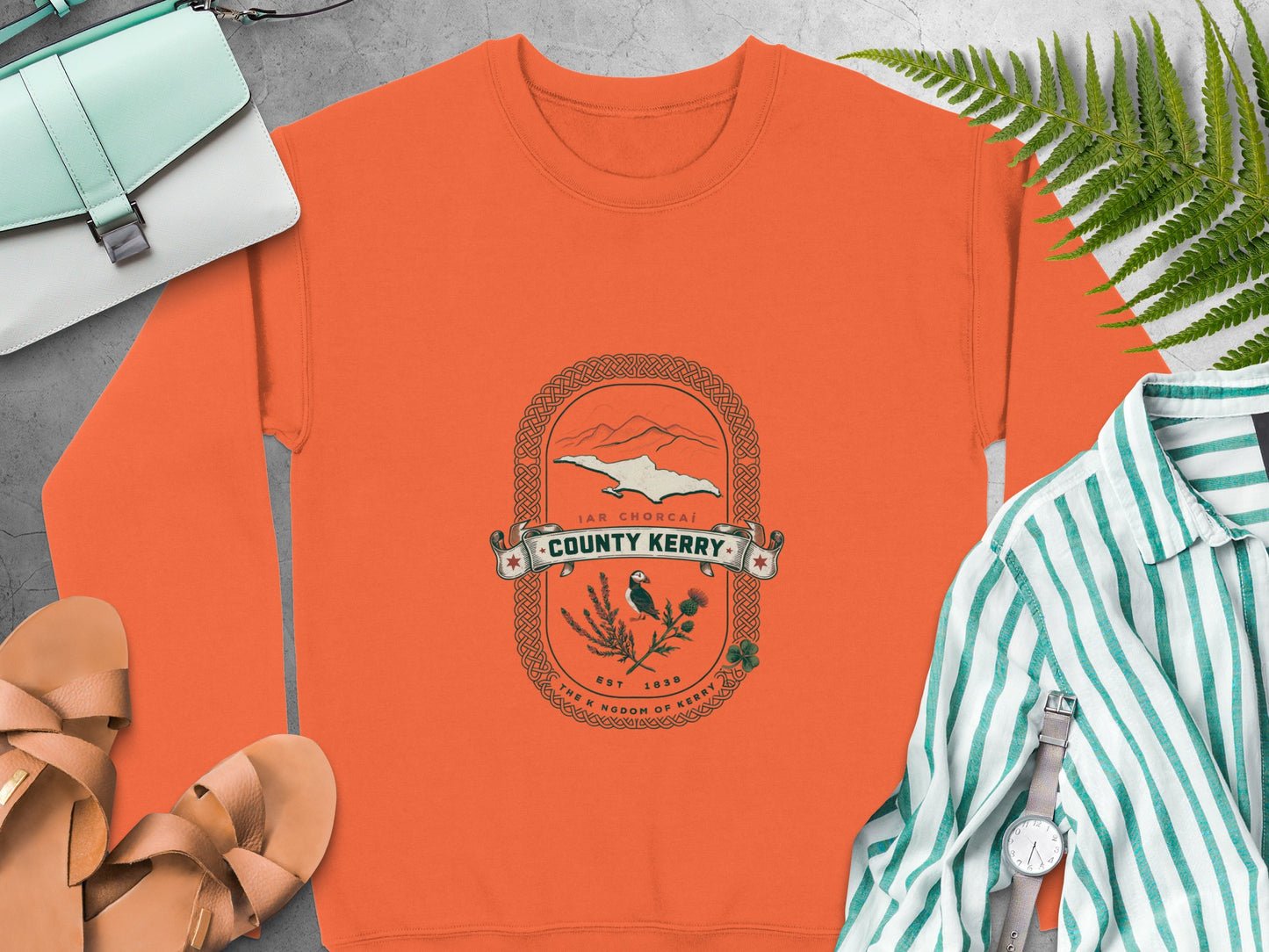 Orange sweatshirt with "County Kerry" crest featuring puffin, thistle, and shamrock.