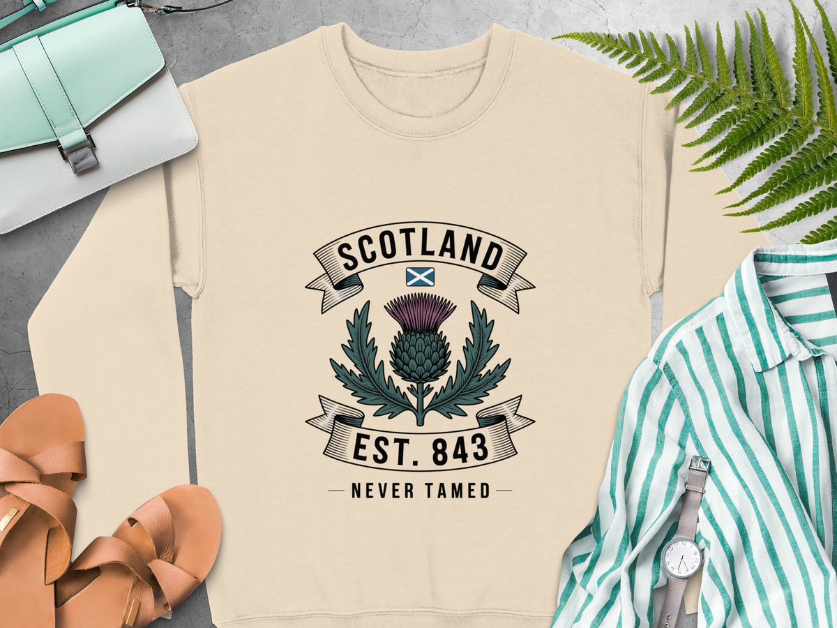 Cream sweatshirt with Scotland thistle crest, est. 843, never tamed.