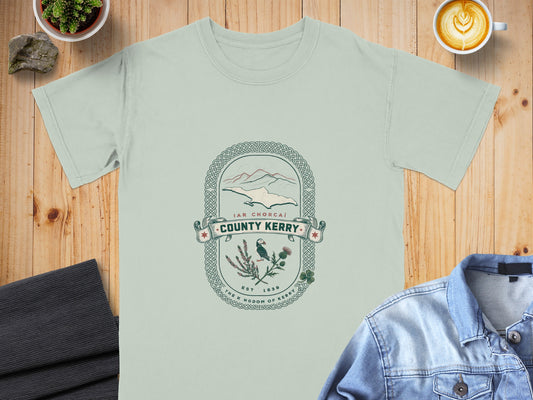 Light green t-shirt with "County Kerry" design featuring mountains, puffin, and thistle.