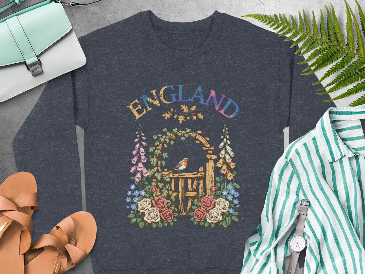 Dark grey sweatshirt with "ENGLAND" text over a garden gate with robin and roses.