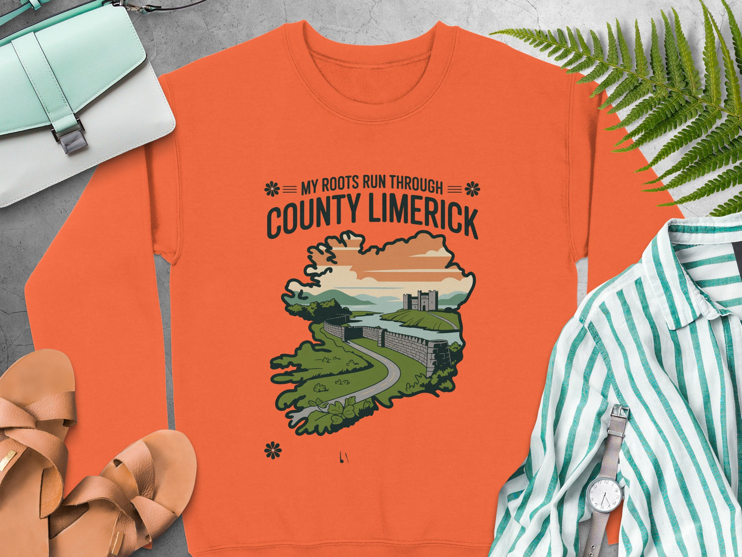 Orange sweatshirt with "My Roots Run Through County Limerick" text and Irish landscape graphic.