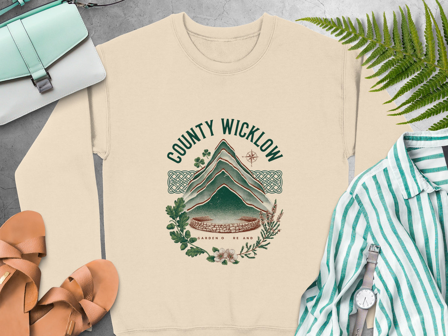 Cream sweatshirt with a "County Wicklow Garden of Ireland" graphic featuring mountains and nature.
