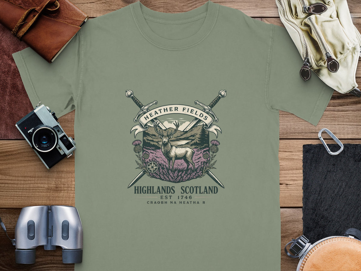 T-shirt with a Scottish crest featuring a deer, swords, thistles, and text.