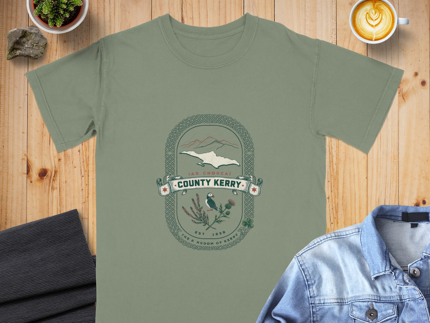 Green t-shirt with County Kerry emblem featuring puffin, thistle, and mountains.