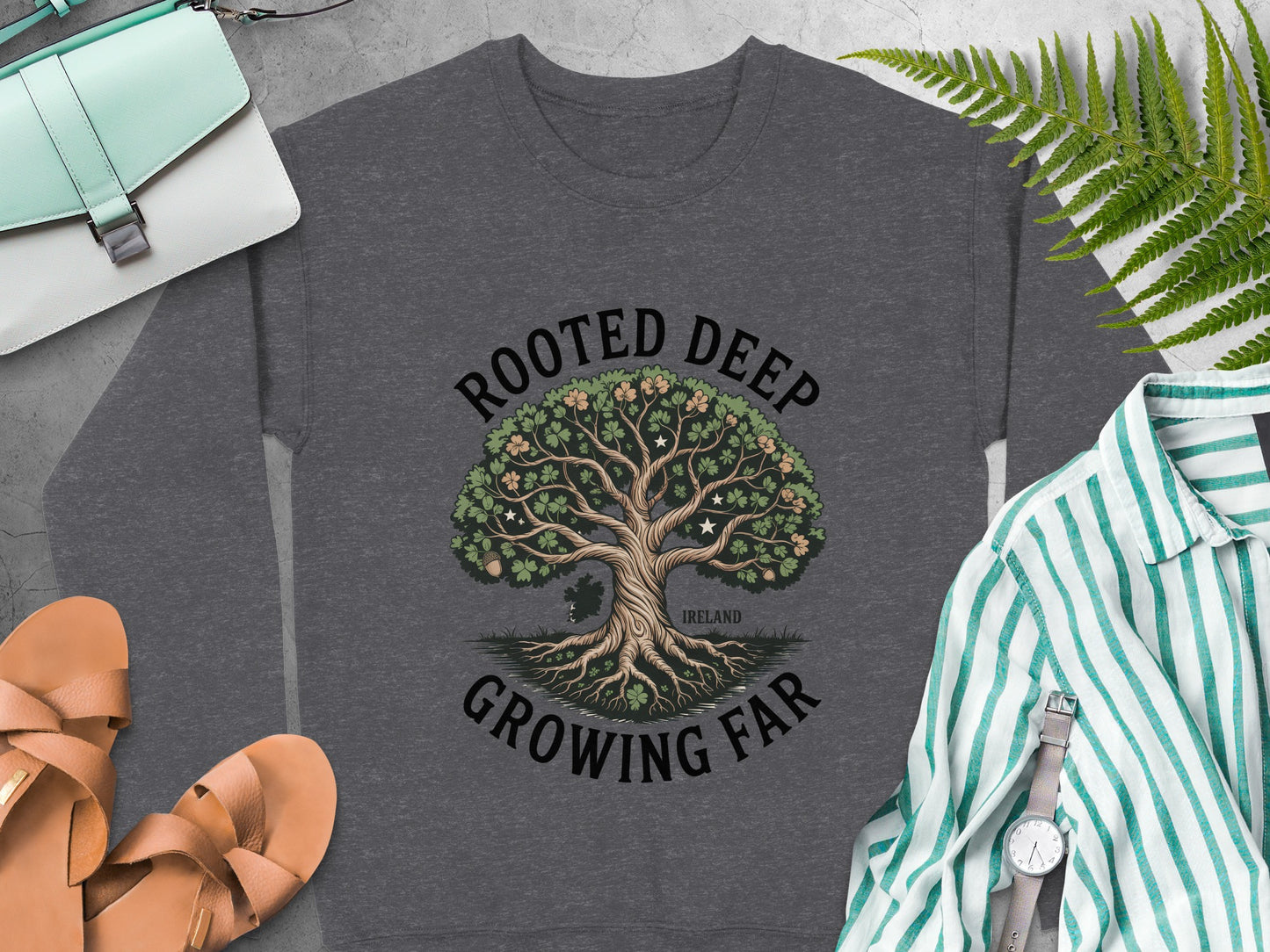 Tree graphic and text "ROOTED DEEP GROWING FAR IRELAND" on Dark Heather sweatshirt