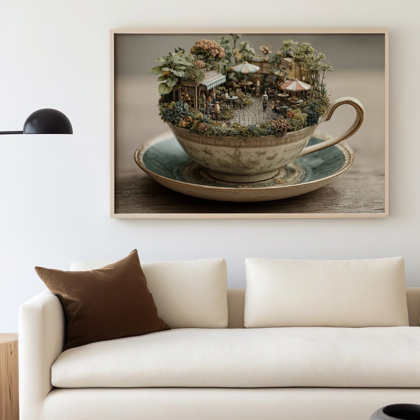 Miniature cafe scene set inside a teacup on a saucer, displayed on a wall.