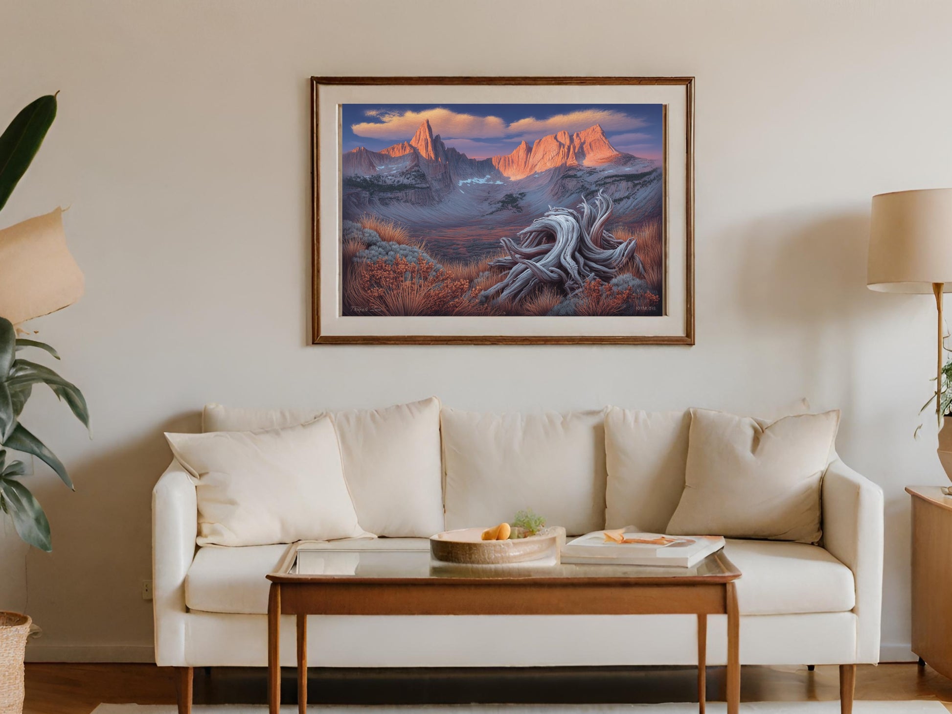 Framed painting of a mountain landscape with a gnarly driftwood in the foreground.