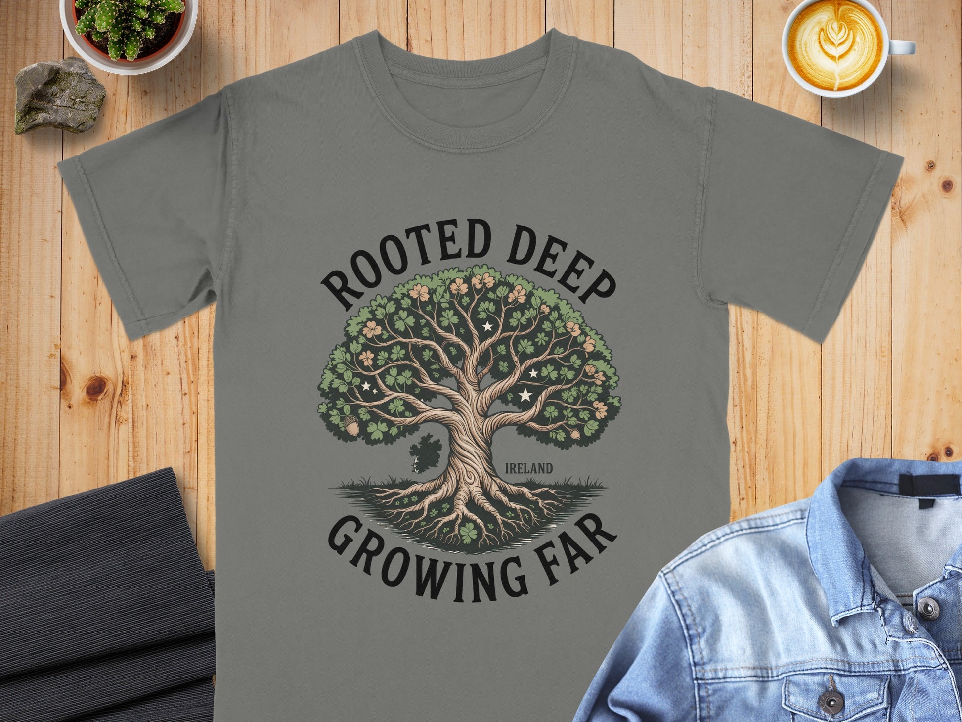 Grey t-shirt with a tree graphic and text "Rooted Deep Growing Far".