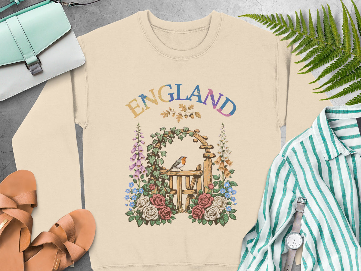 Cream sweatshirt with an "ENGLAND" graphic featuring a robin and garden gate.