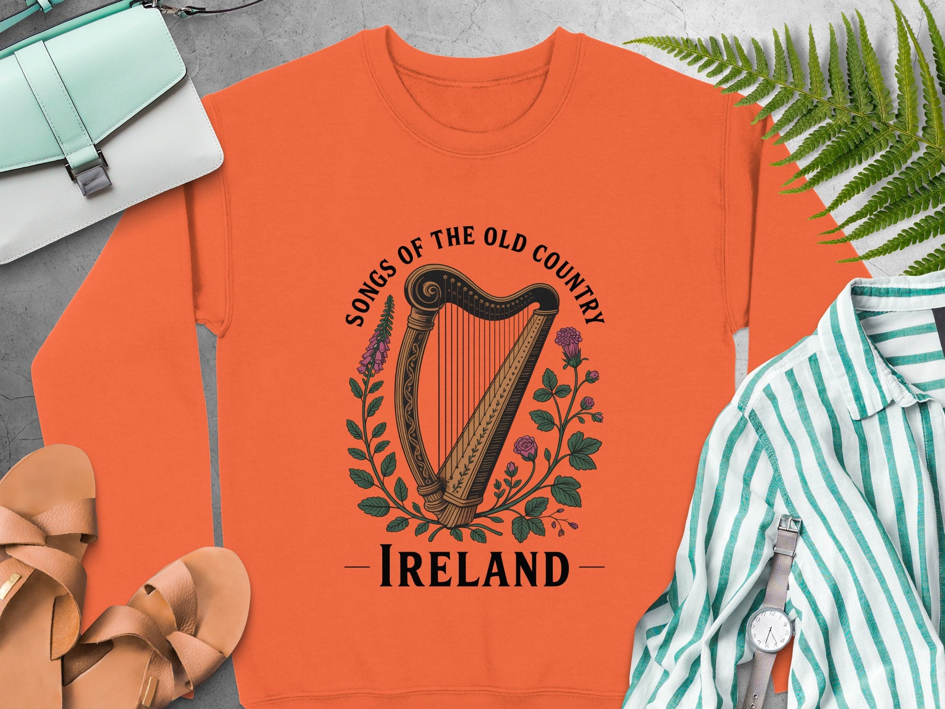 Orange sweatshirt with a harp, flowers, and "Songs of the Old Country — Ireland" text.