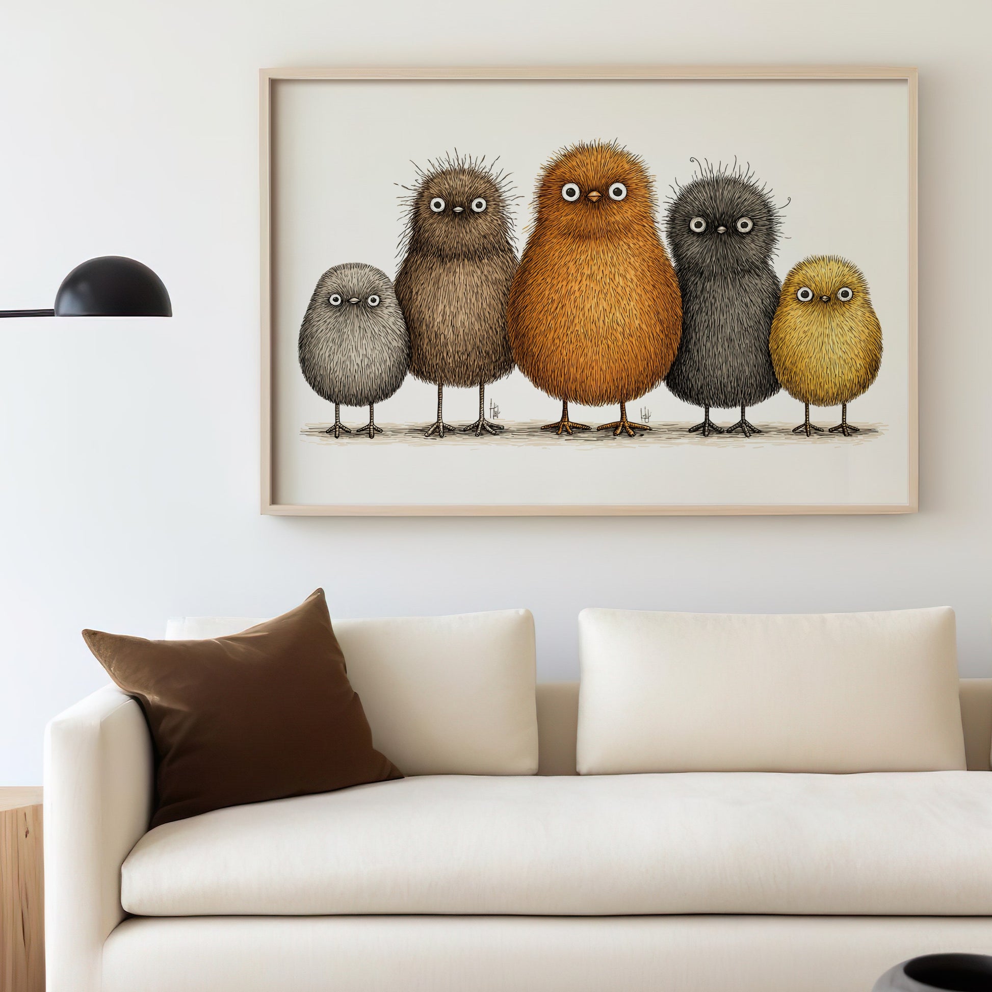 Five cartoonish birds in a framed picture hang above a cream sofa.