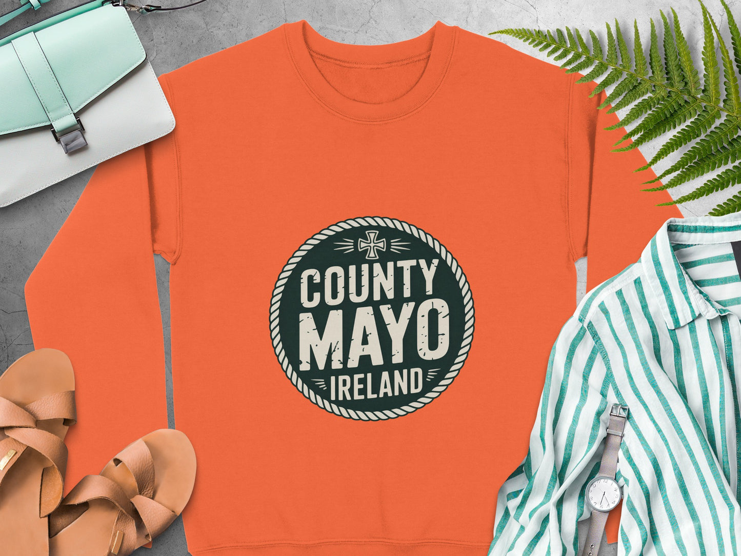 Orange sweatshirt with "County Mayo Ireland" text graphic.