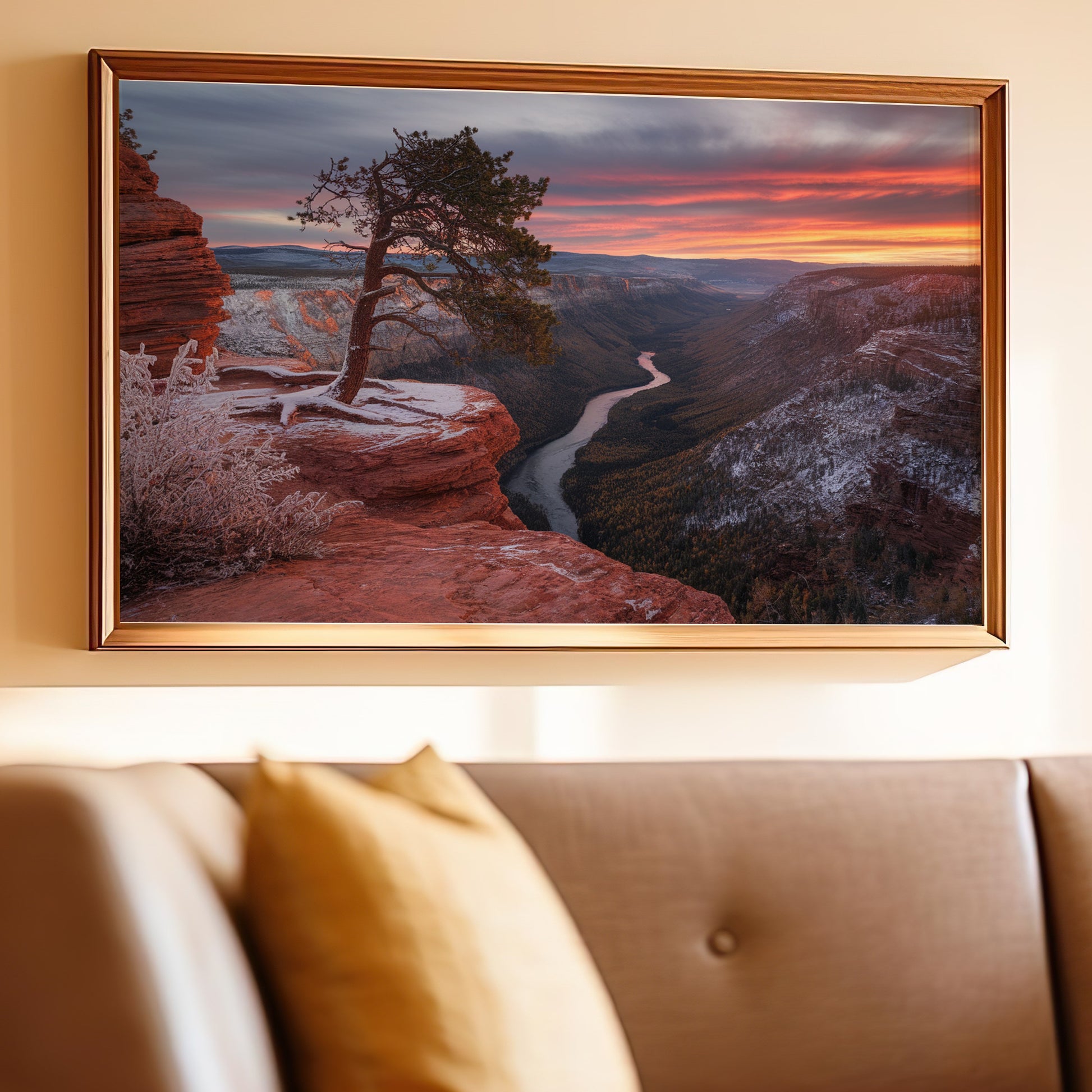 Framed artwork of a tree on a cliff edge overlooking a river valley at sunset.
