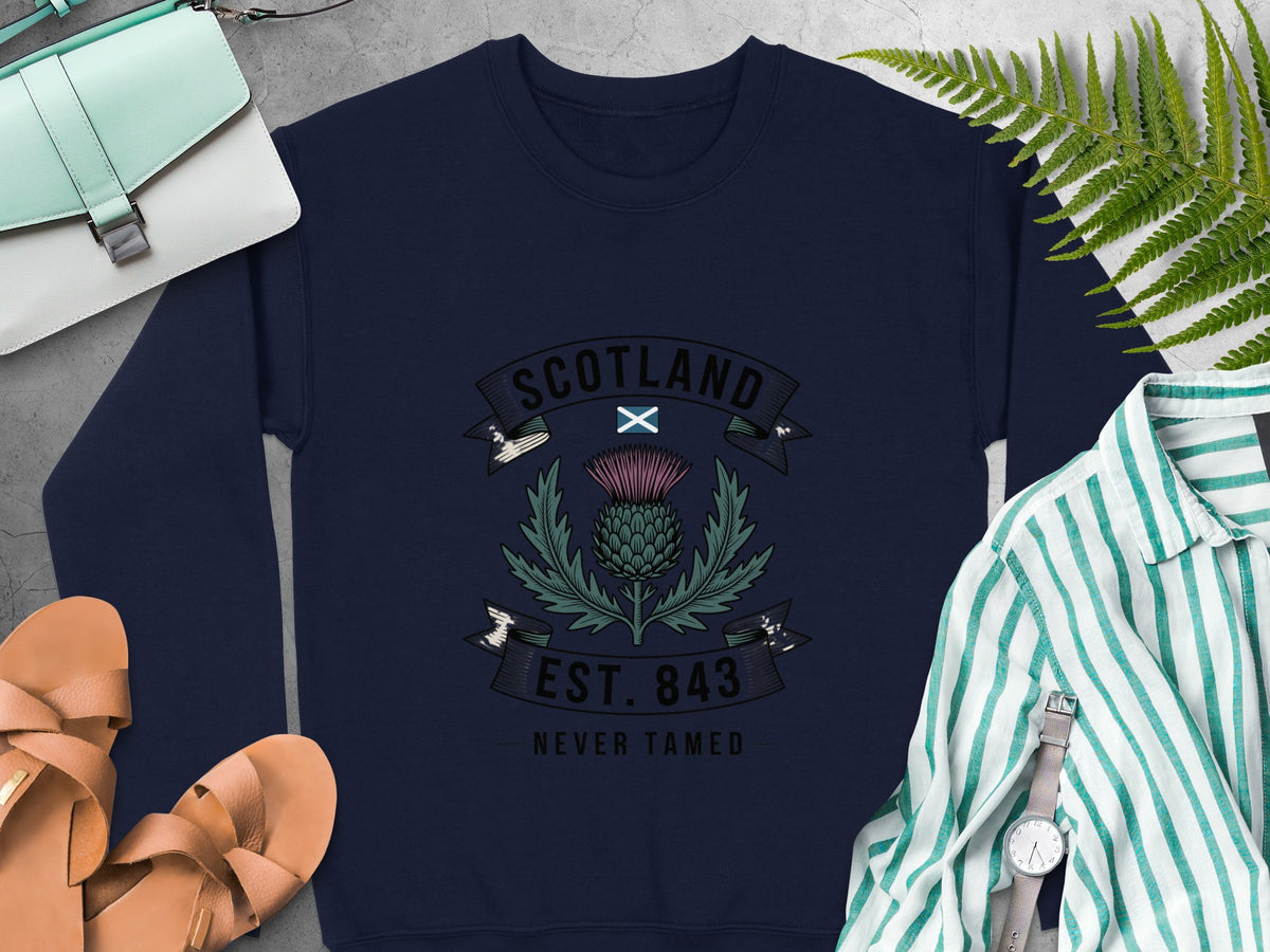 Navy sweatshirt with Scotland crest, thistle, and text "EST. 843 NEVER TAMED".