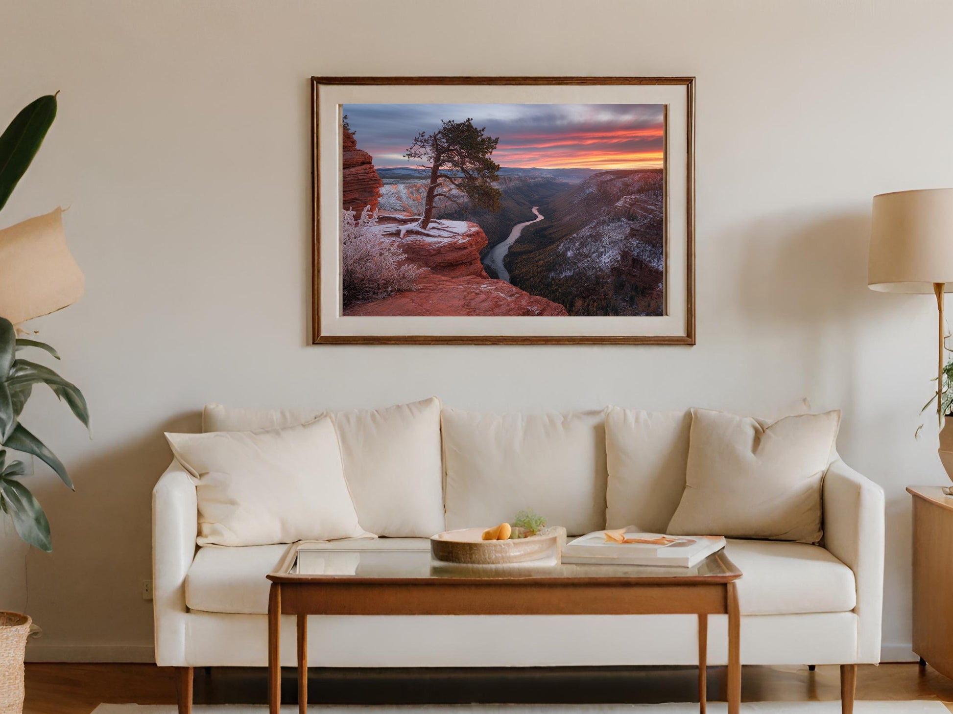 Framed landscape artwork of a tree on a cliff overlooking a canyon at sunset.