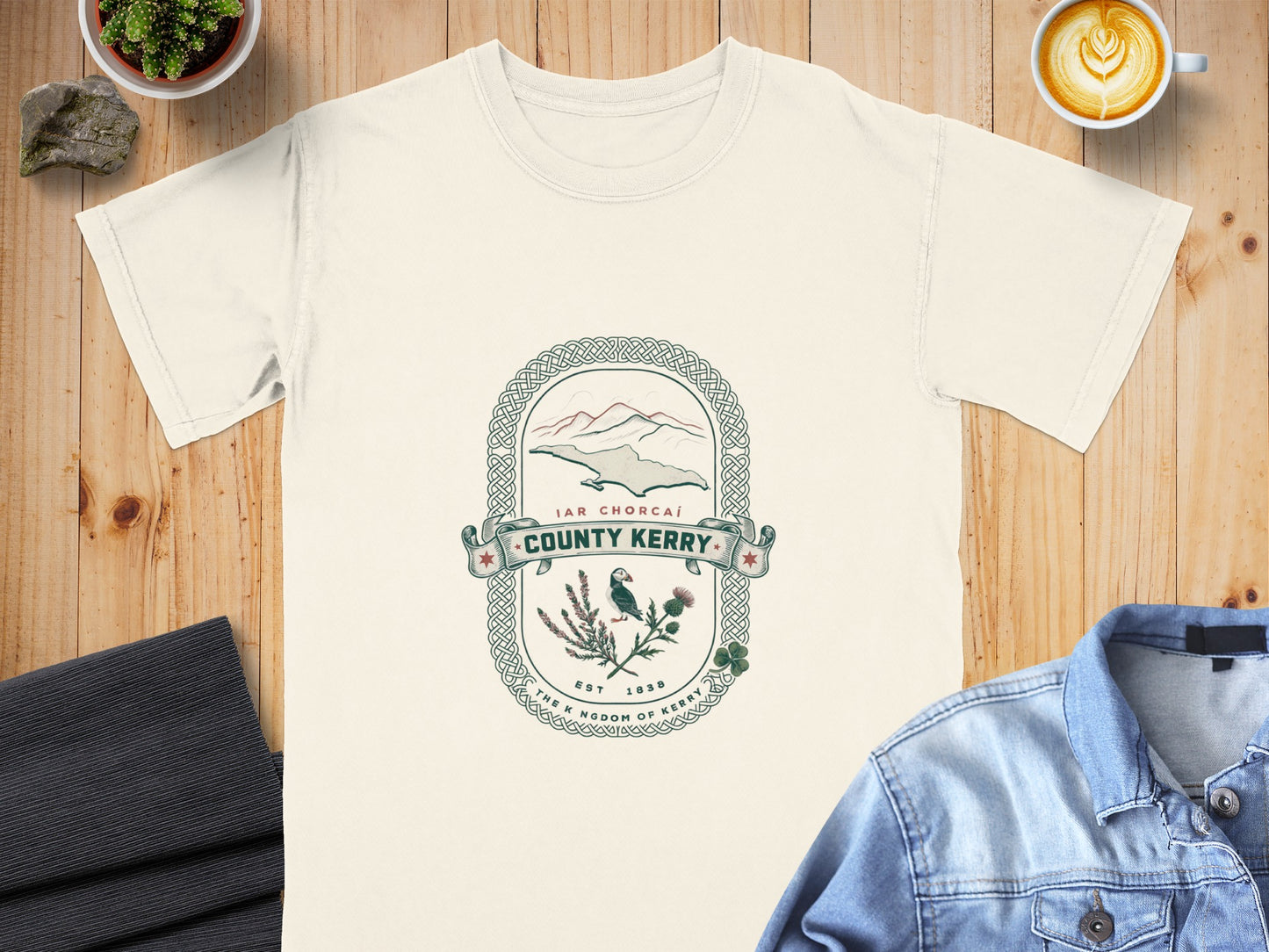 Cream t-shirt featuring a crest for County Kerry with a puffin and landscape.