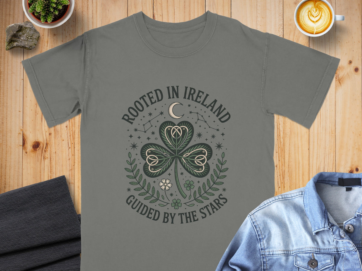 Grey t-shirt with "Rooted in Ireland Guided by the Stars" text and shamrock design.