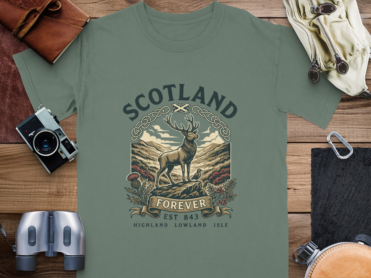 Green t-shirt with Scotland Forever graphic featuring a stag, thistle, and mountains.