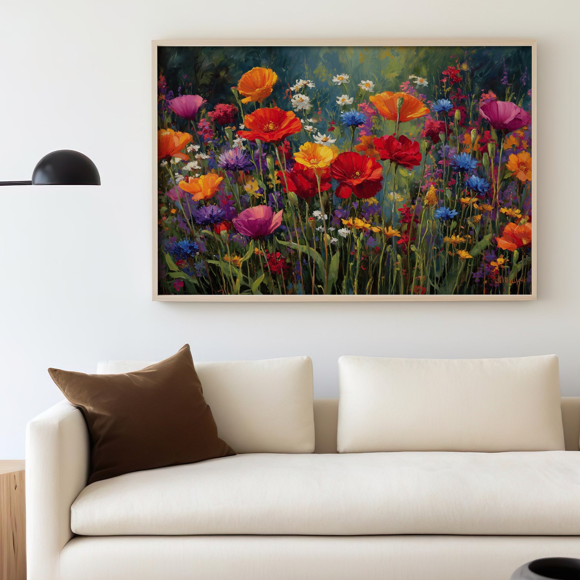 Colorful wildflower painting hanging above a cream sofa with a brown pillow.