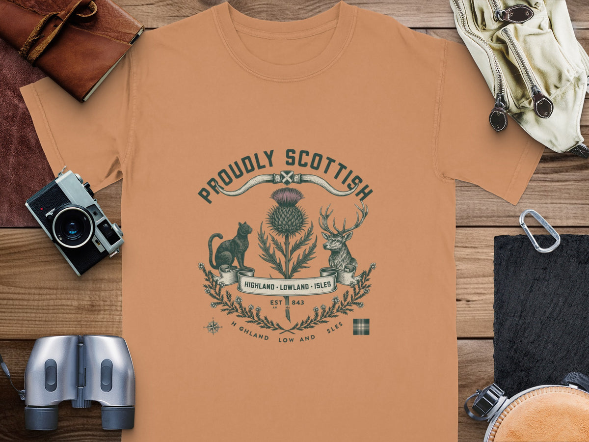 Orange t-shirt with "Proudly Scottish" text, thistle, cat, deer, and map elements.