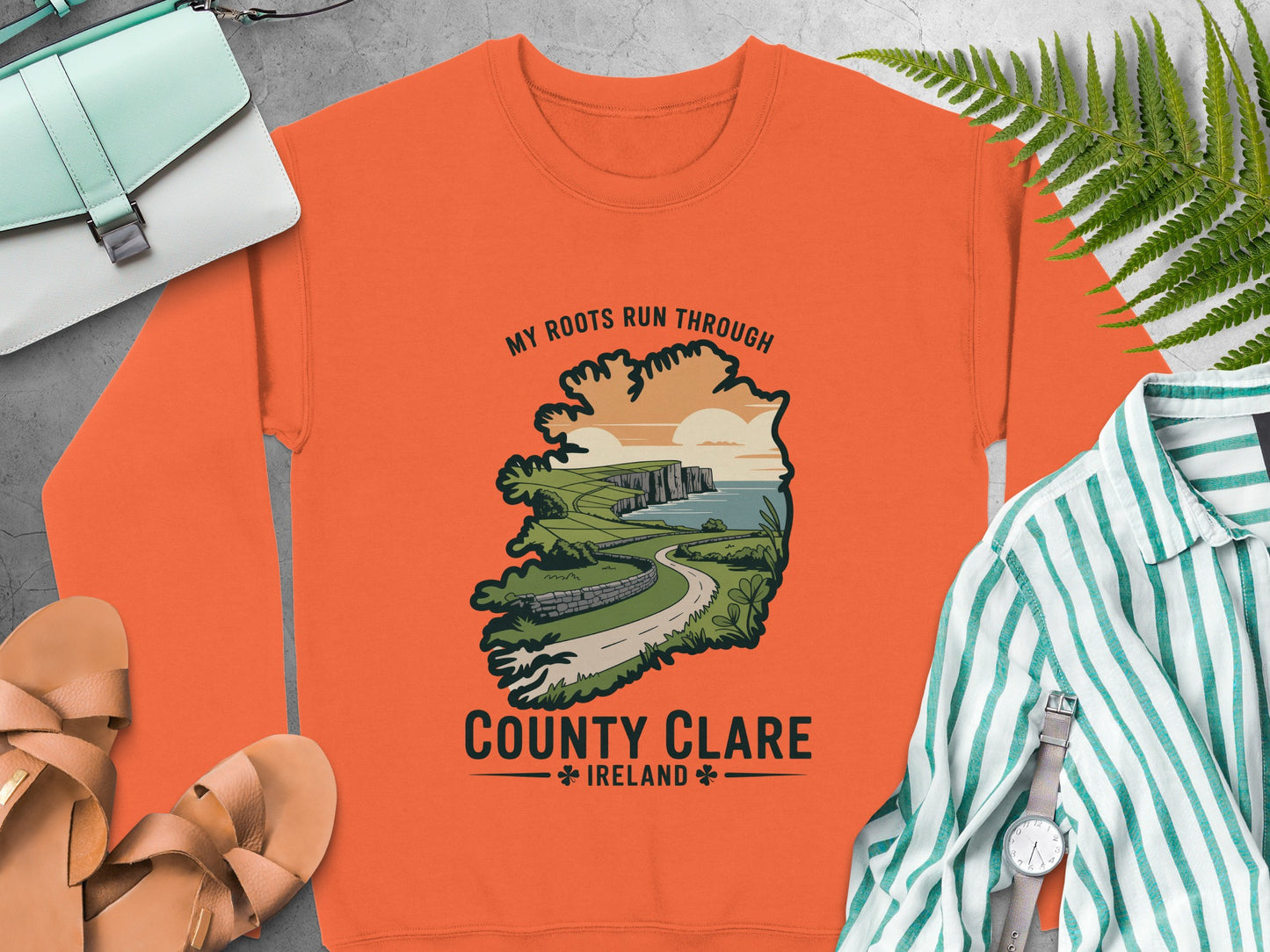 Orange sweatshirt with County Clare Ireland graphic and text.
